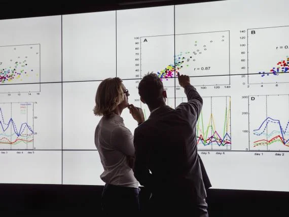 two people reviewing graphs